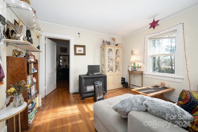 living room with hardwood / wood-style floors and crown molding