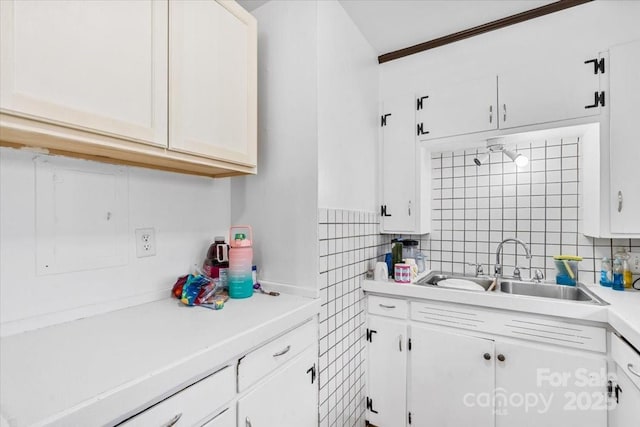 kitchen featuring white cabinets and sink