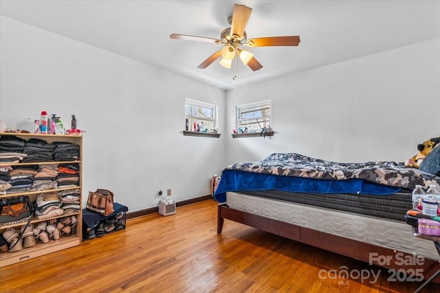 bedroom featuring hardwood / wood-style floors and ceiling fan