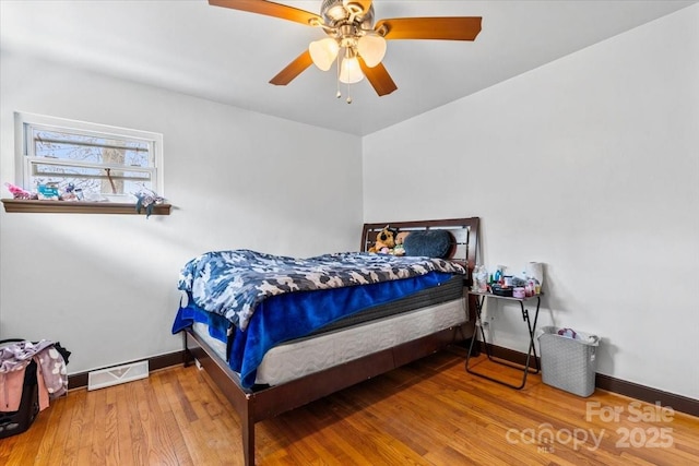 bedroom with wood-type flooring and ceiling fan