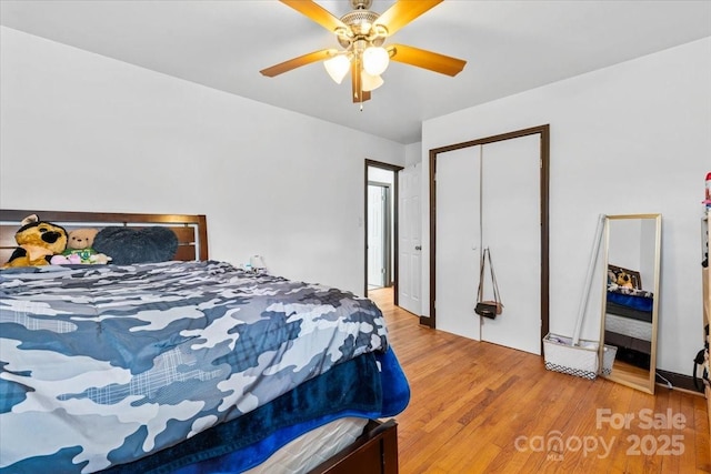 bedroom featuring a closet, hardwood / wood-style flooring, and ceiling fan