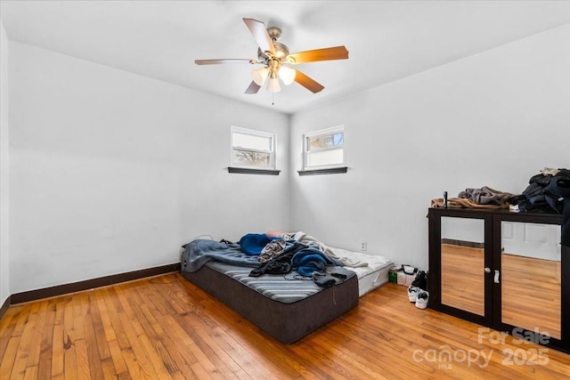 bedroom with hardwood / wood-style floors and ceiling fan