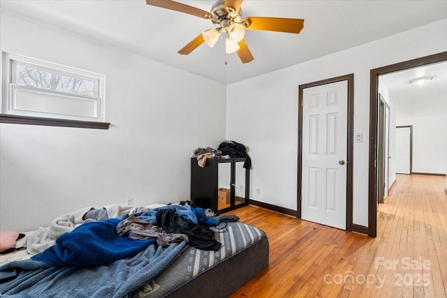 bedroom with ceiling fan and wood-type flooring