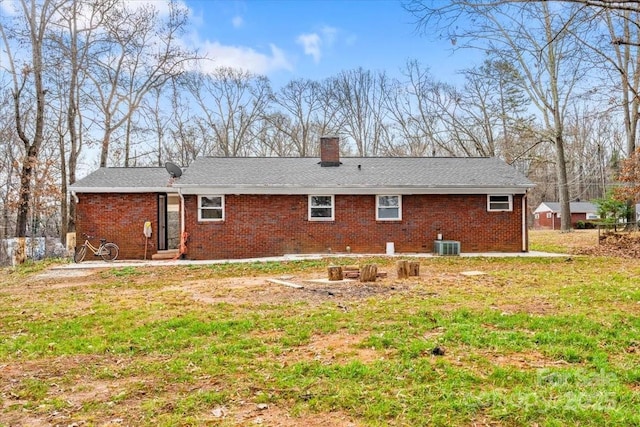 back of house with a yard and central AC unit