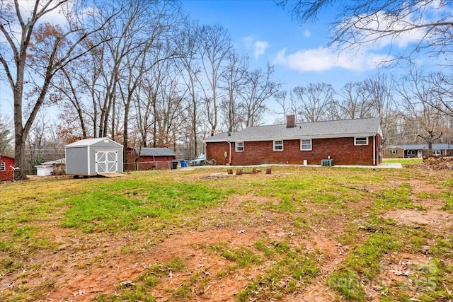 exterior space featuring central AC unit and a shed