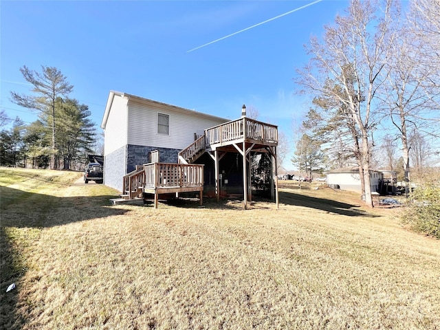 back of property featuring a lawn and a wooden deck