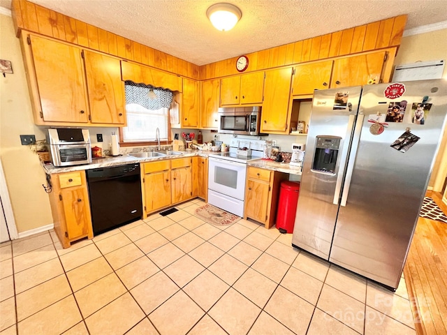 kitchen featuring ornamental molding, a textured ceiling, stainless steel appliances, sink, and light tile patterned flooring