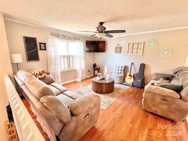 living room with ceiling fan, wood-type flooring, and ornamental molding