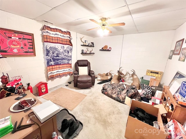 interior space featuring a drop ceiling and ceiling fan