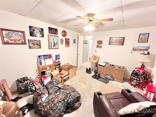 game room featuring carpet flooring, ceiling fan, and a drop ceiling