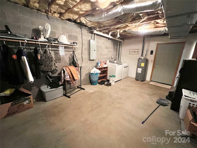 basement featuring washer and dryer, electric water heater, and electric panel