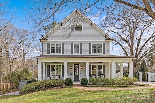 view of front property with a porch, ceiling fan, and a front yard