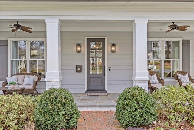 view of exterior entry with covered porch and ceiling fan