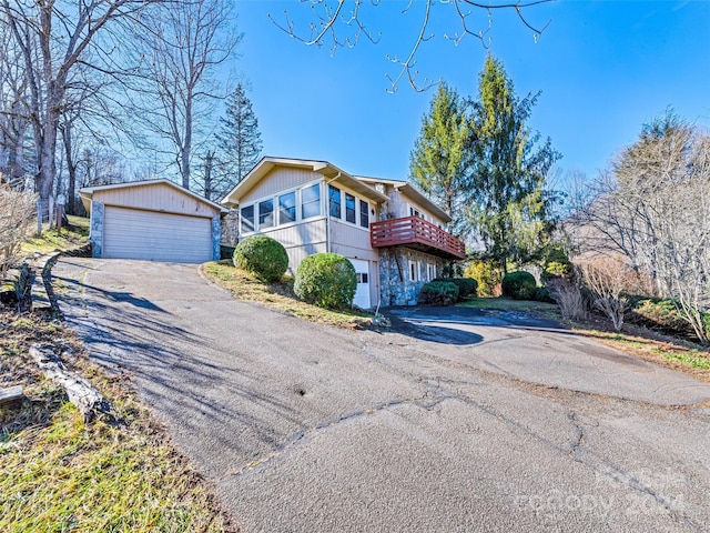 view of property featuring an outbuilding and a garage