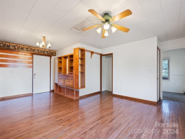 interior space with hardwood / wood-style floors and ceiling fan with notable chandelier