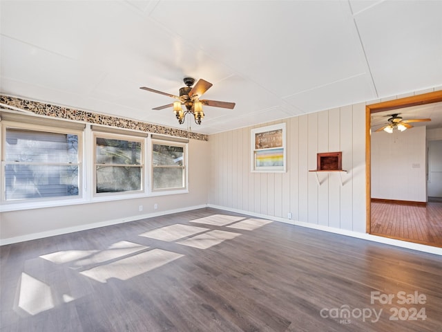 spare room featuring ceiling fan and dark hardwood / wood-style flooring