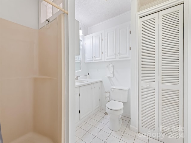 bathroom with vanity, crown molding, tile patterned flooring, toilet, and a textured ceiling