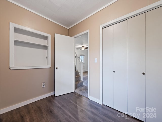 unfurnished bedroom featuring dark hardwood / wood-style flooring and ornamental molding