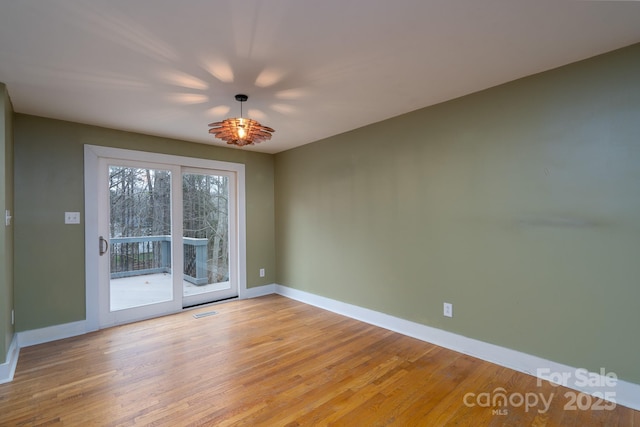 spare room with light hardwood / wood-style floors