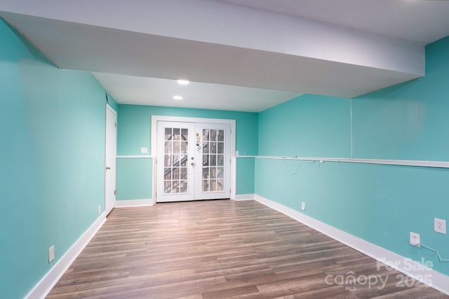 empty room with french doors and hardwood / wood-style flooring