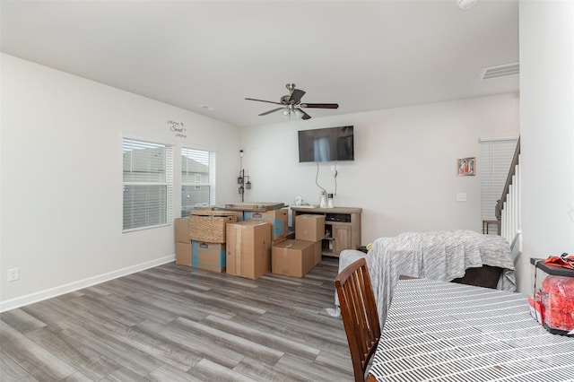 bedroom with light hardwood / wood-style flooring and ceiling fan