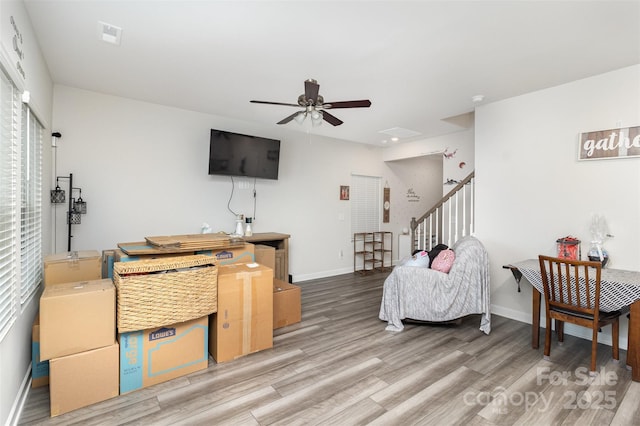 living room featuring ceiling fan and hardwood / wood-style floors