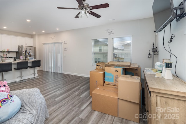 living room featuring ceiling fan and light wood-type flooring