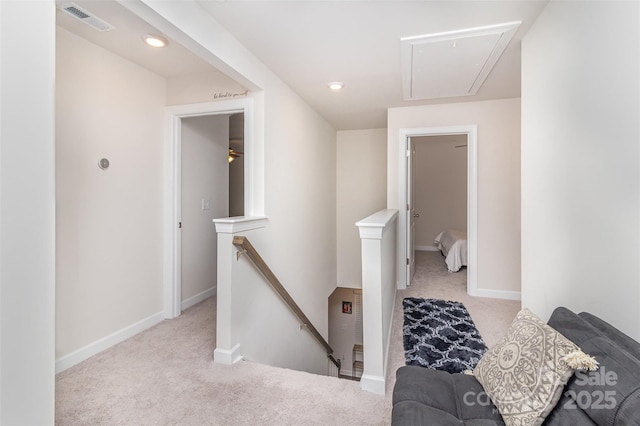 hallway featuring light colored carpet