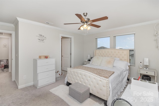 carpeted bedroom featuring ceiling fan and crown molding