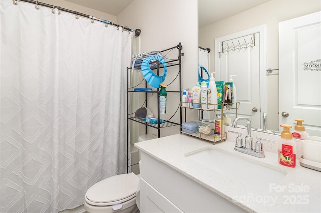 bathroom featuring vanity and toilet