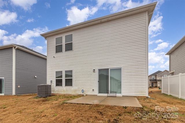 back of property featuring a lawn, a patio area, and central AC