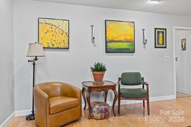 sitting room with hardwood / wood-style flooring