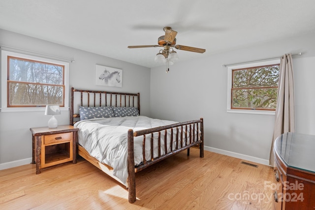 bedroom with ceiling fan and light hardwood / wood-style flooring