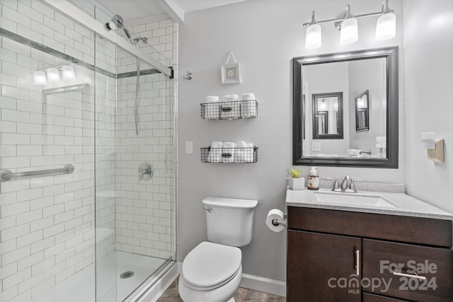 bathroom with vanity, toilet, and an enclosed shower