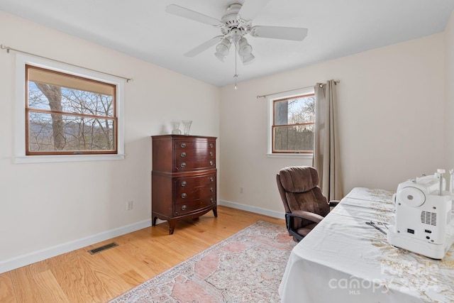 office space with ceiling fan and light wood-type flooring