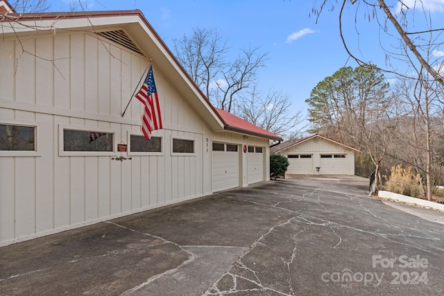 view of home's exterior featuring an outdoor structure and a garage