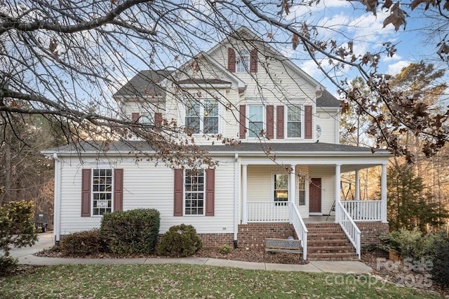 view of front of property with a porch and roof with shingles