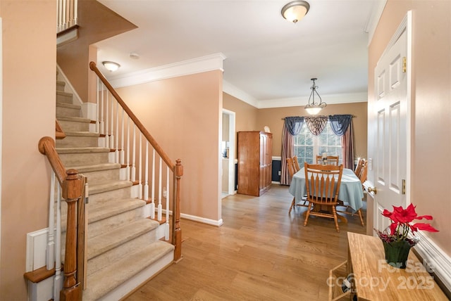 dining room featuring ornamental molding and light hardwood / wood-style floors