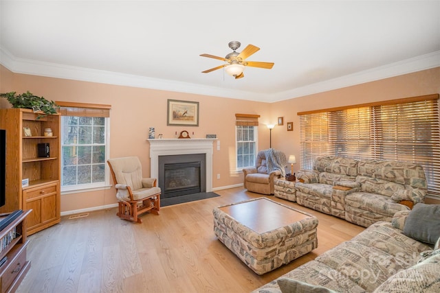 living room featuring light wood-type flooring, ceiling fan, and crown molding