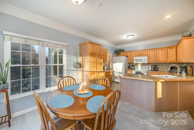 kitchen with white appliances, kitchen peninsula, light tile patterned floors, ornamental molding, and sink