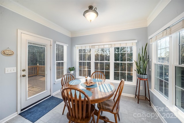 dining area featuring light tile patterned flooring and crown molding