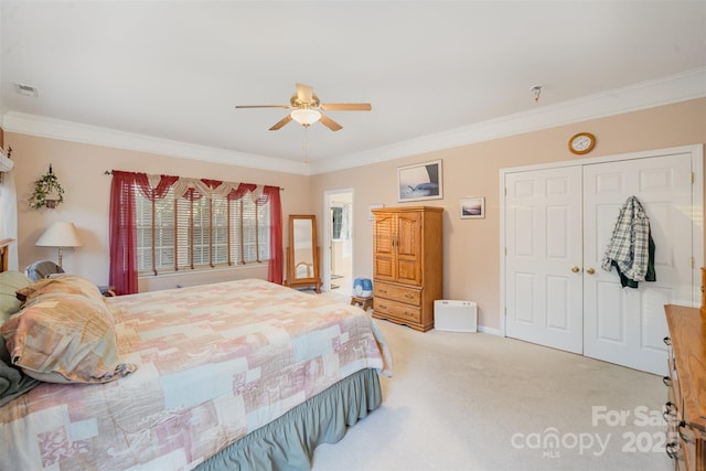 carpeted bedroom featuring a closet, ceiling fan, and ornamental molding