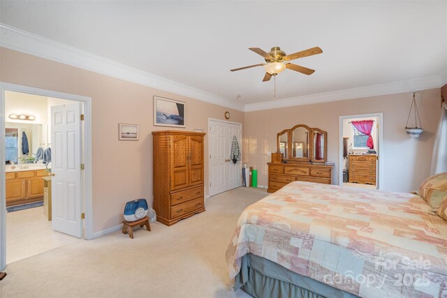 carpeted bedroom featuring connected bathroom, ceiling fan, and ornamental molding