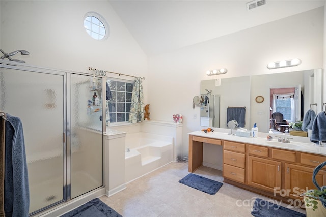 bathroom with separate shower and tub, lofted ceiling, and vanity