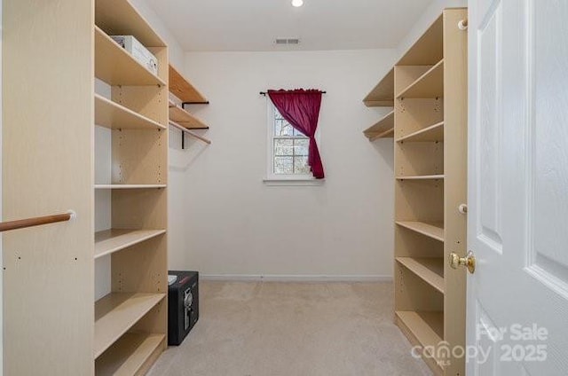 walk in closet featuring carpet flooring and visible vents