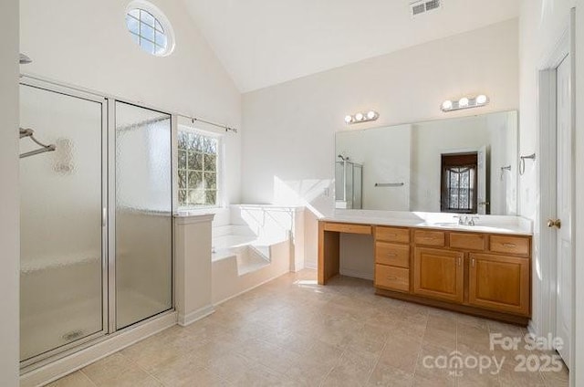 bathroom with high vaulted ceiling, a garden tub, vanity, visible vents, and a stall shower