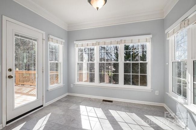 unfurnished sunroom with a healthy amount of sunlight and visible vents