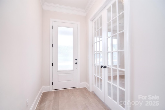 doorway to outside with light wood-type flooring, baseboards, crown molding, and french doors