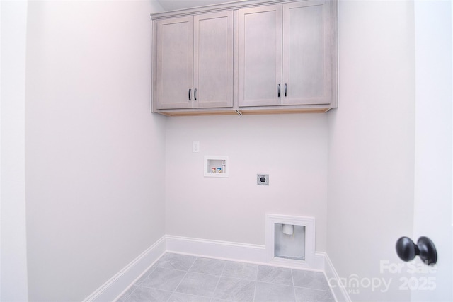 washroom with baseboards, hookup for a washing machine, cabinet space, and hookup for an electric dryer