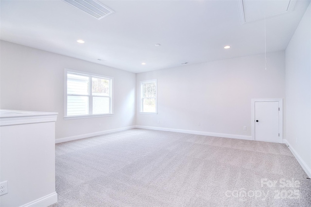 empty room with recessed lighting, light colored carpet, visible vents, attic access, and baseboards